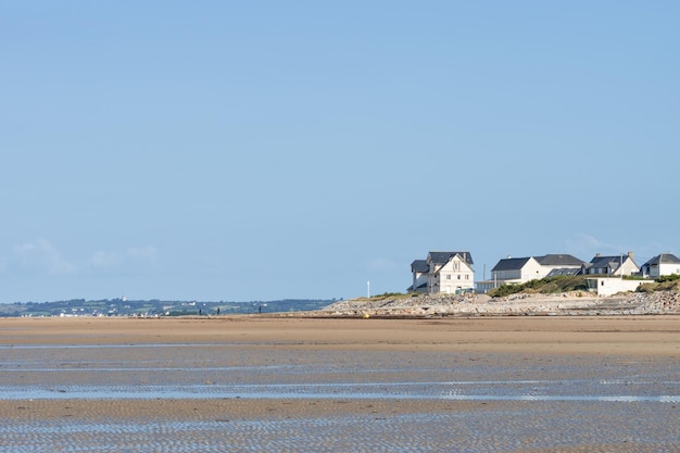 Scenic view of beach against clear blue sky