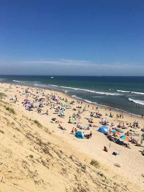 Scenic view of beach against clear blue sky