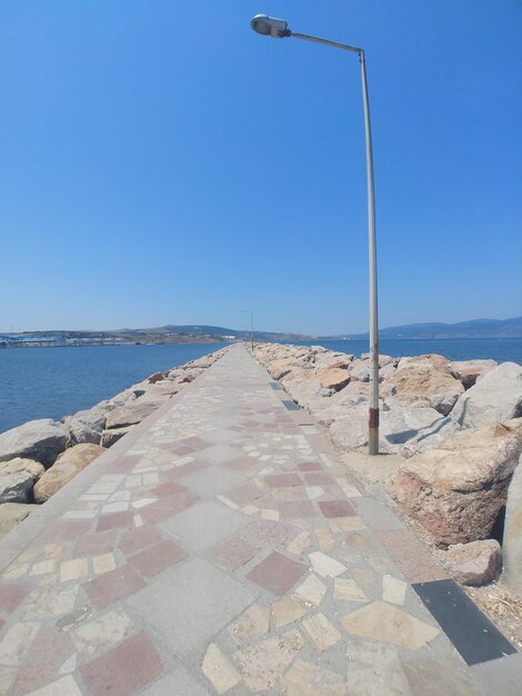 Scenic view of beach against clear blue sky