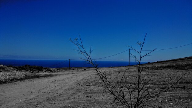 Scenic view of beach against clear blue sky