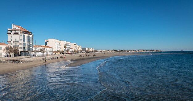 Scenic view of beach against clear blue sky