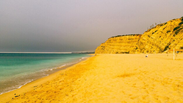 Scenic view of beach against clear sky