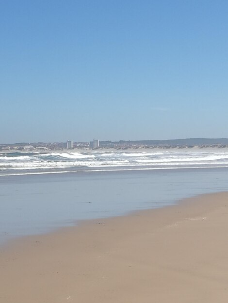 Scenic view of beach against clear sky