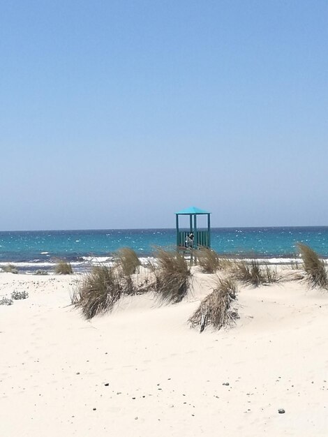 Scenic view of beach against clear sky