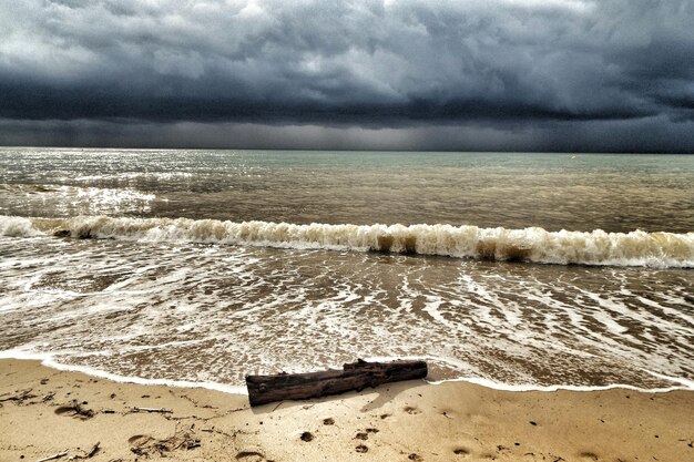 Scenic view of beach against cloudy sky