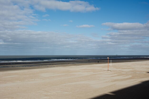 Scenic view of beach against cloudy sky