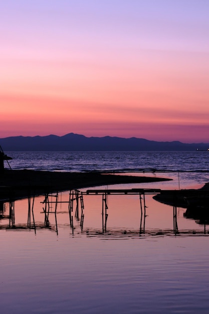 Scenic view of beach against orange sky