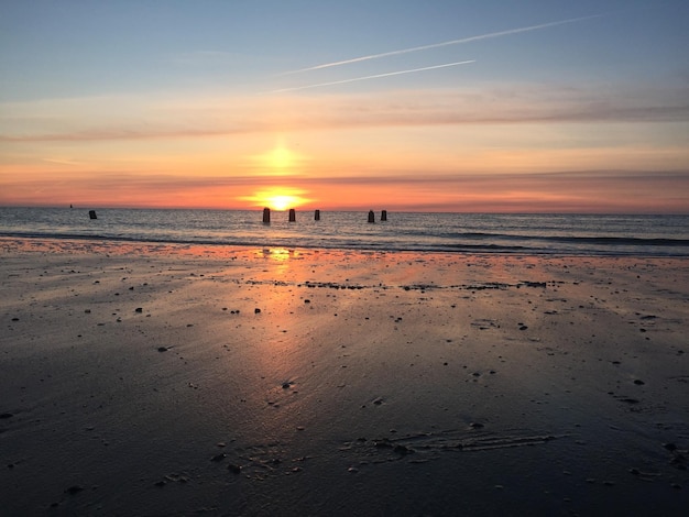 Scenic view of beach against sky during sunset