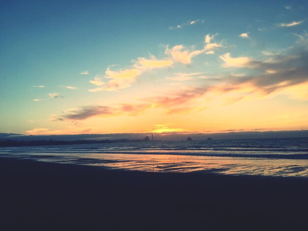 Scenic view of beach against sky during sunset