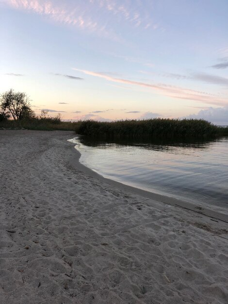 Scenic view of beach against sky during sunset