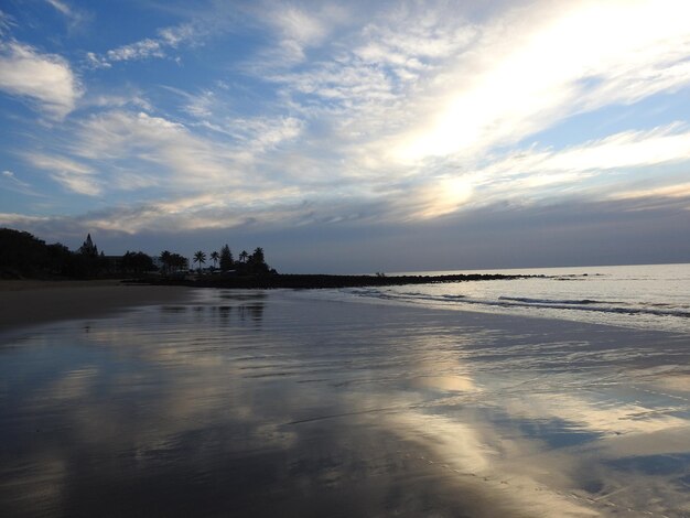 Scenic view of beach against sky during sunset