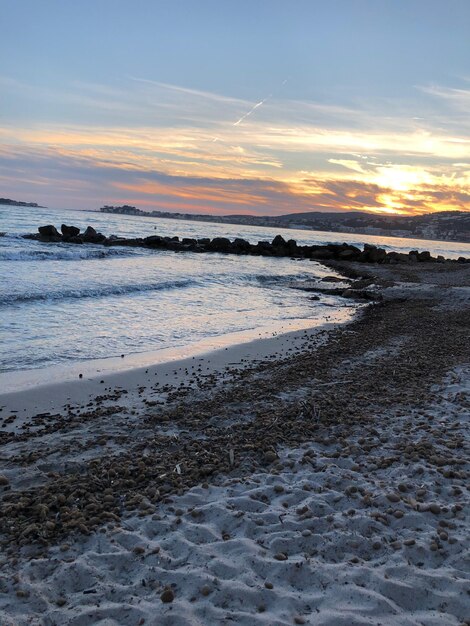 Scenic view of beach against sky during sunset