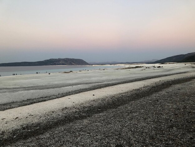 Scenic view of beach against sky during sunset