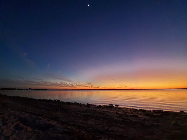 Scenic view of beach against sky during sunset