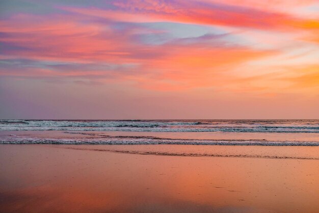 Photo scenic view of beach against sky during sunset