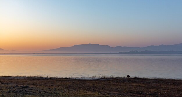 Scenic view of beach against sky during sunset