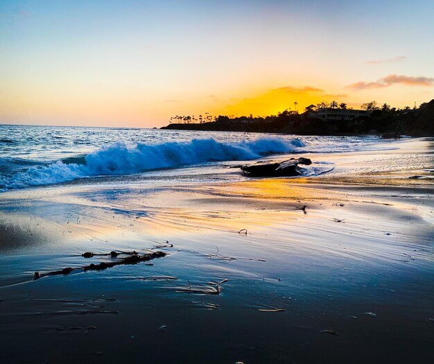 Scenic view of beach against sky during sunset