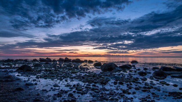 Scenic view of beach against sky during sunset