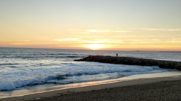 Scenic view of beach against sky during sunset