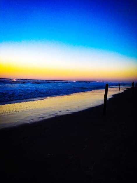 Scenic view of beach against sky during sunset