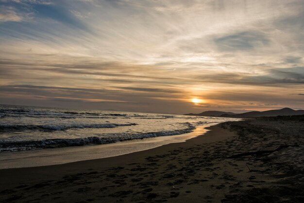 Scenic view of beach against sky during sunset