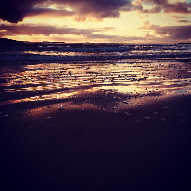 Scenic view of beach against sky during sunset