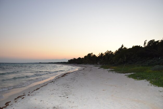 Scenic view of beach against sky during sunset