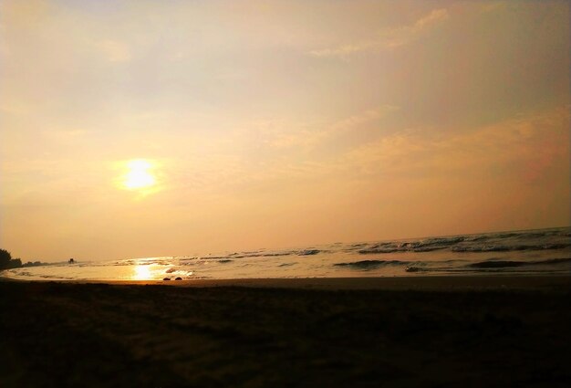 Scenic view of beach against sky during sunset