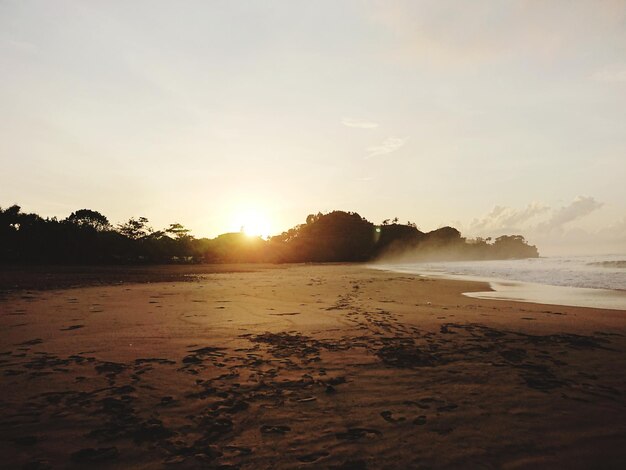 Scenic view of beach against sky during sunset