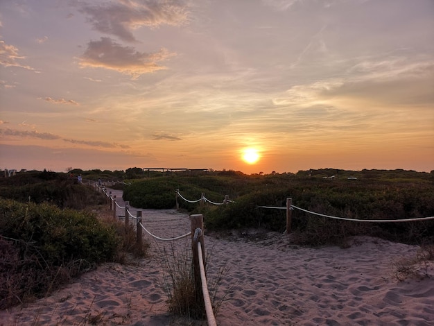 Scenic view of beach against sky during sunset