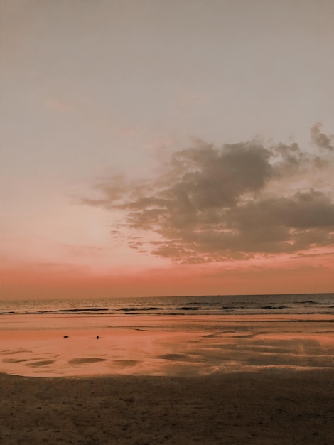 Scenic view of beach against sky during sunset