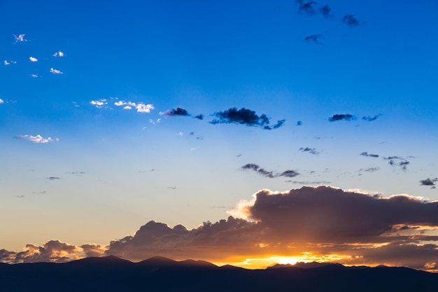 Scenic view of a beautiful sunset with blue sky and clouds over the mountains