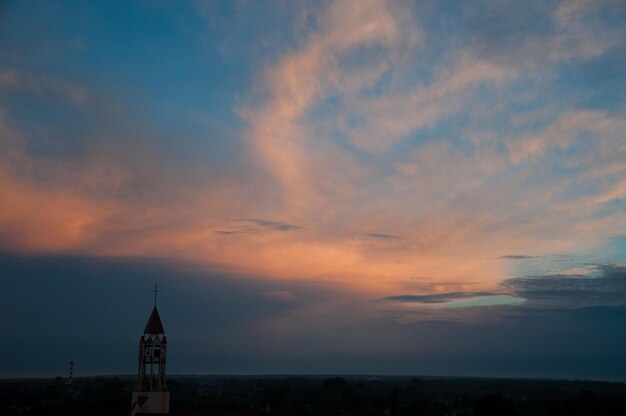 Scenic view of building against sky during sunset