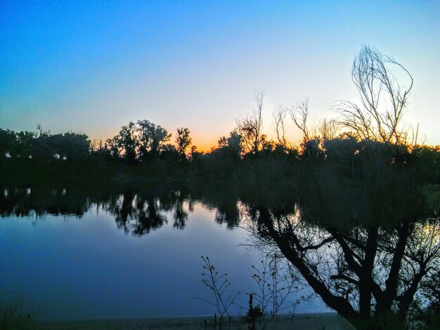 Scenic view of calm lake against clear sky