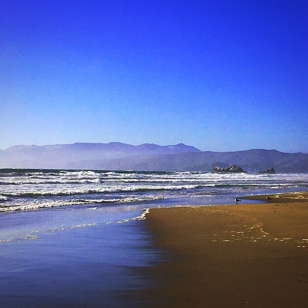 Scenic view of calm sea against blue sky