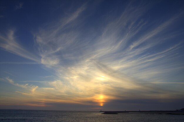 Scenic view of calm sea against cloudy sky