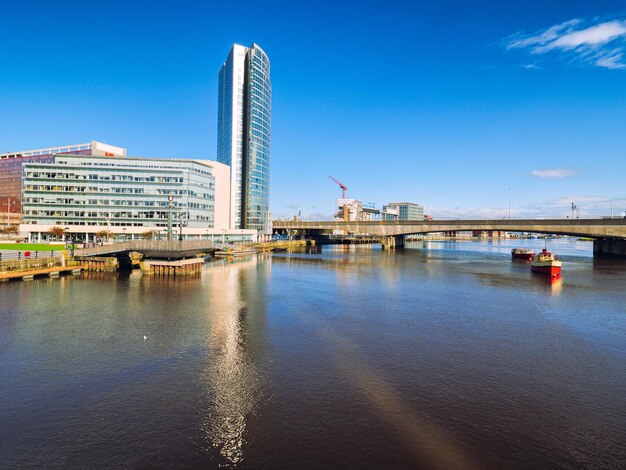 Scenic view of city against clear blue sky