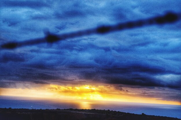 Scenic view of cloudy sky at sunset