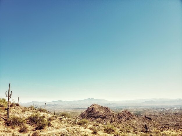 Photo scenic view of desert against clear blue sky