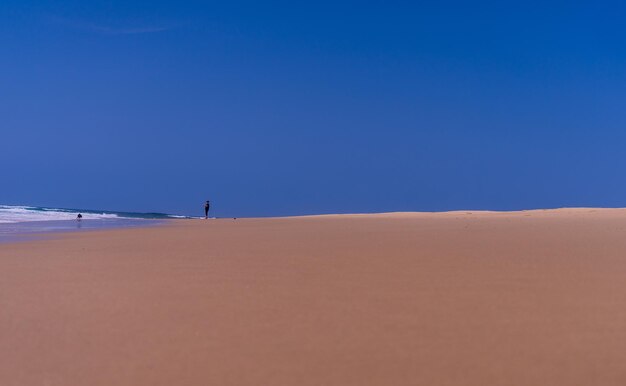 Scenic view of desert against clear blue sky