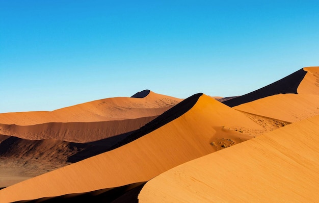 Scenic view of desert against clear blue sky