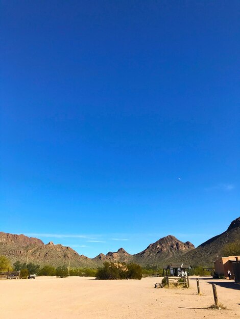 Scenic view of desert against clear blue sky