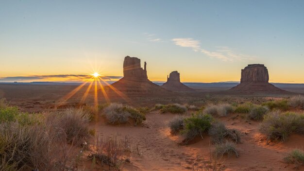 Photo scenic view of desert against sky during sunset