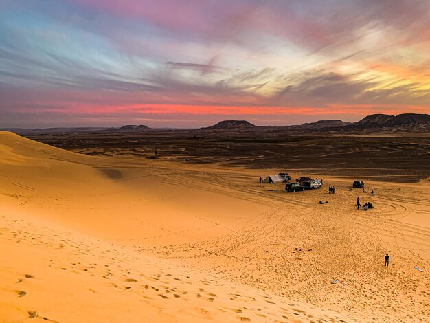 Scenic view of desert against sky during sunset