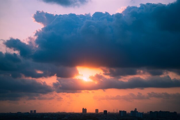 Scenic view of dramatic sky over city during sunset