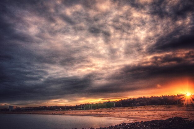 Scenic view of dramatic sky over silhouette landscape