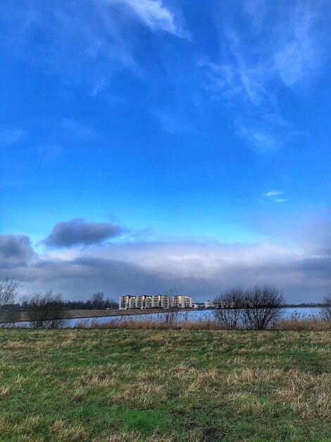 Scenic view of field against blue sky