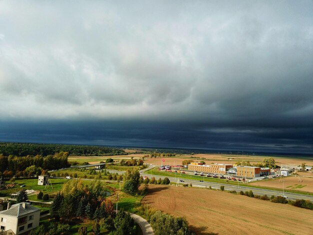 Scenic view of field against cloudy sky