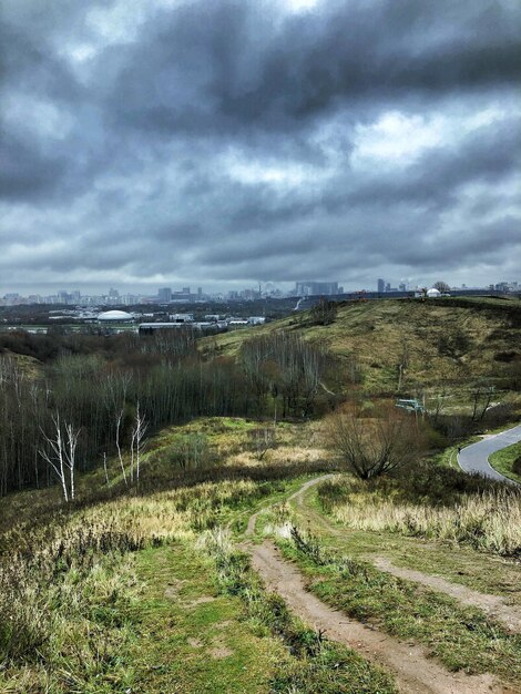 Scenic view of field against cloudy sky