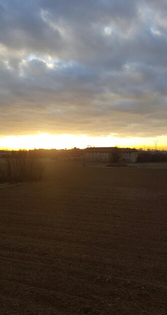 Scenic view of field against sky during sunset